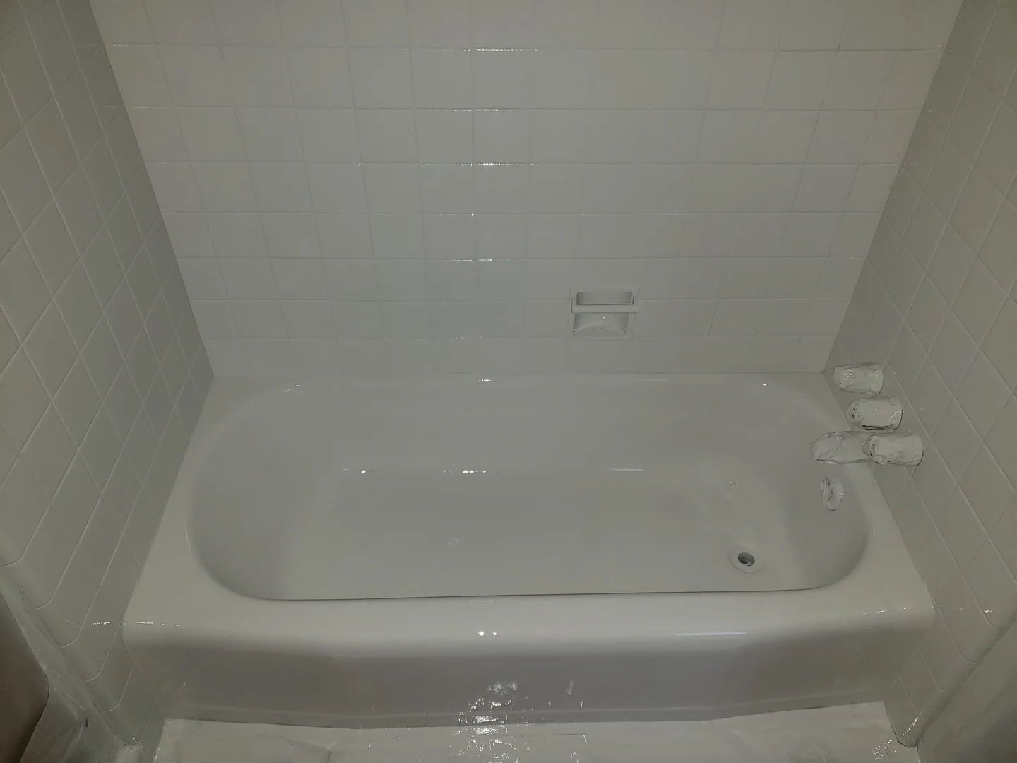 A white bathtub and tile surround from the Dab Hands project gallery